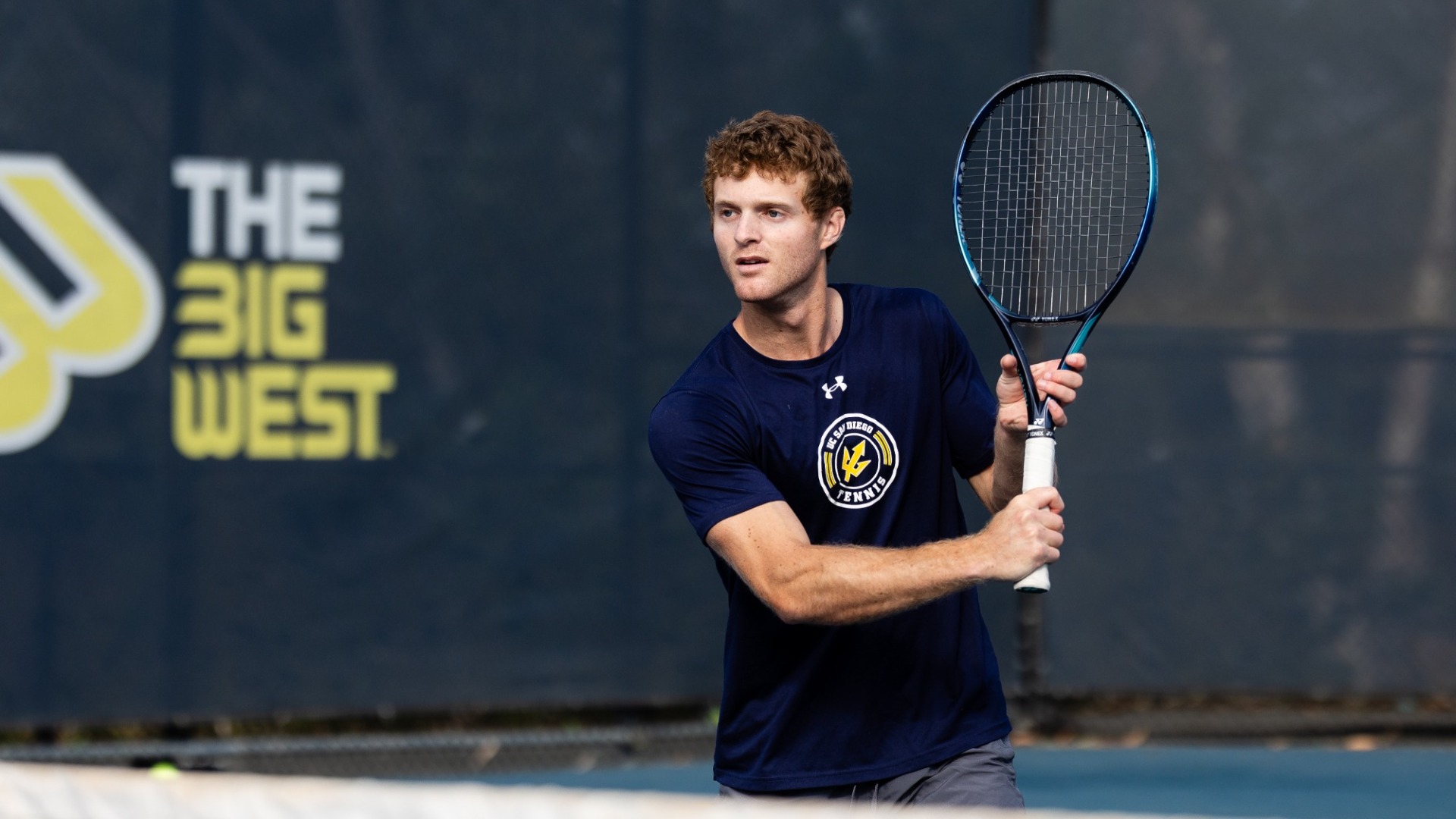 Oliver Worth preparing to hit a tennis ball