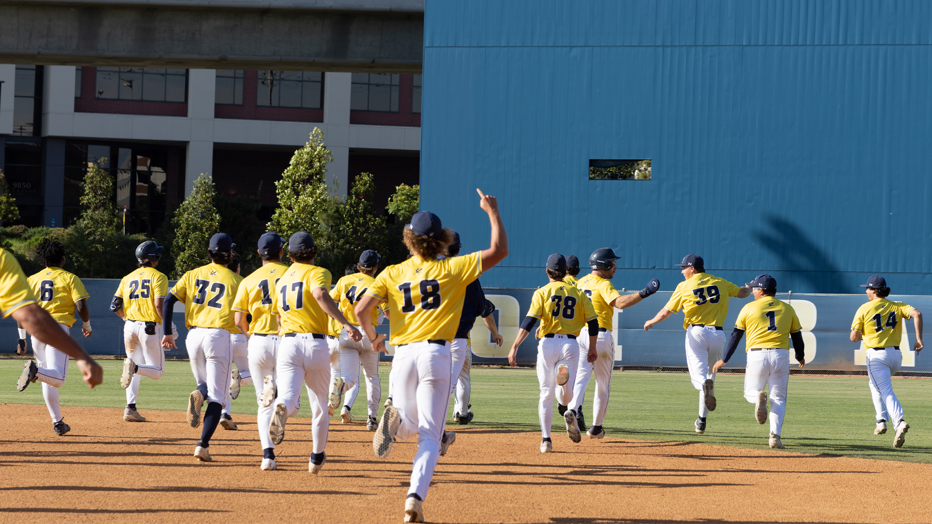 Baseball team runs towards center field in celebration