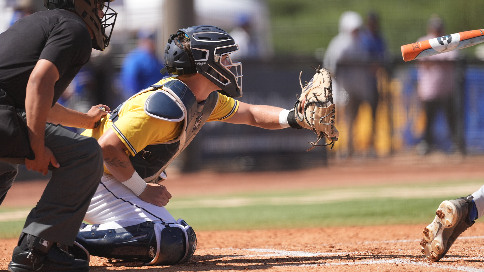 Trevian Martinez in catchers gear crouches to catch a pitch