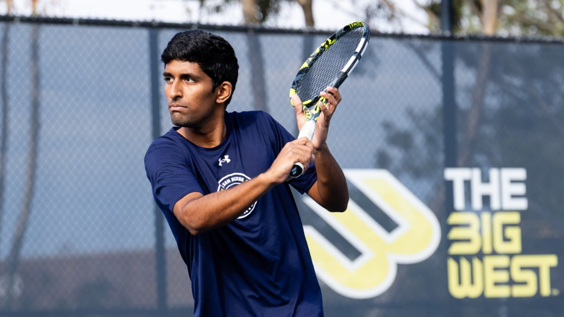 UC San Diego tennis player Prathinav Chunduru prepares to return a ball with his racquet in hand