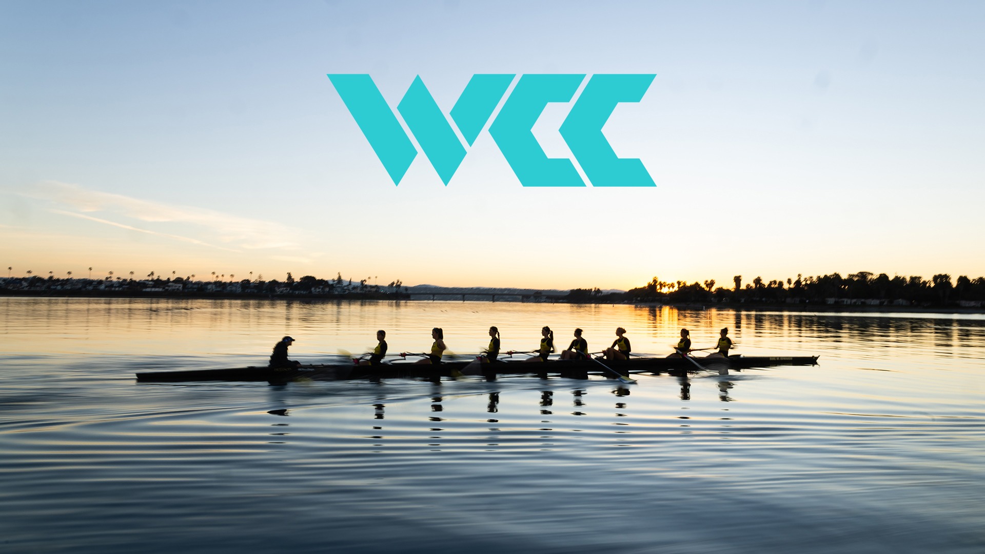 Women's rowing out on a glassy Mission Bay with WCC logo