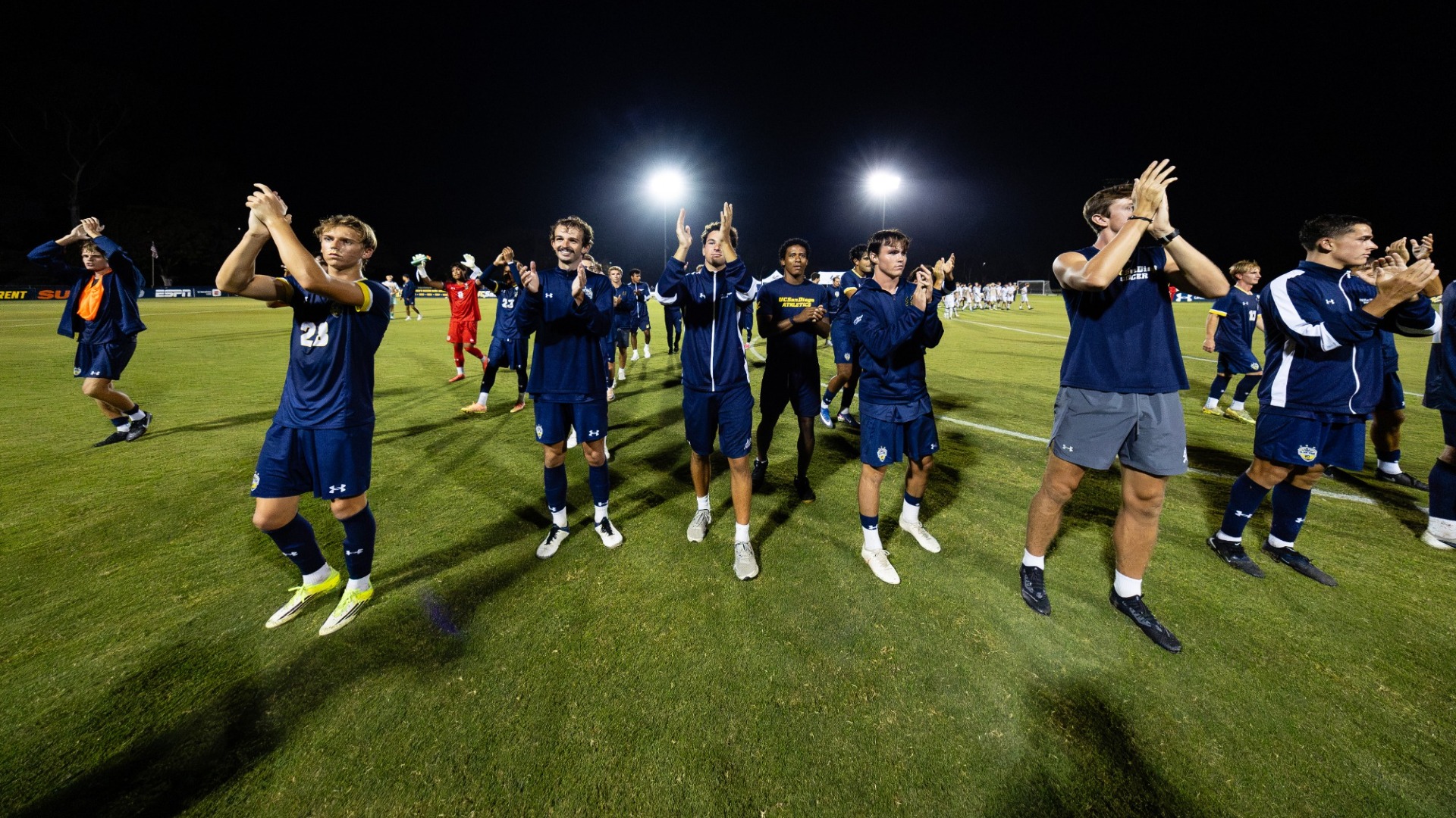 Men's Soccer team clapping after a game