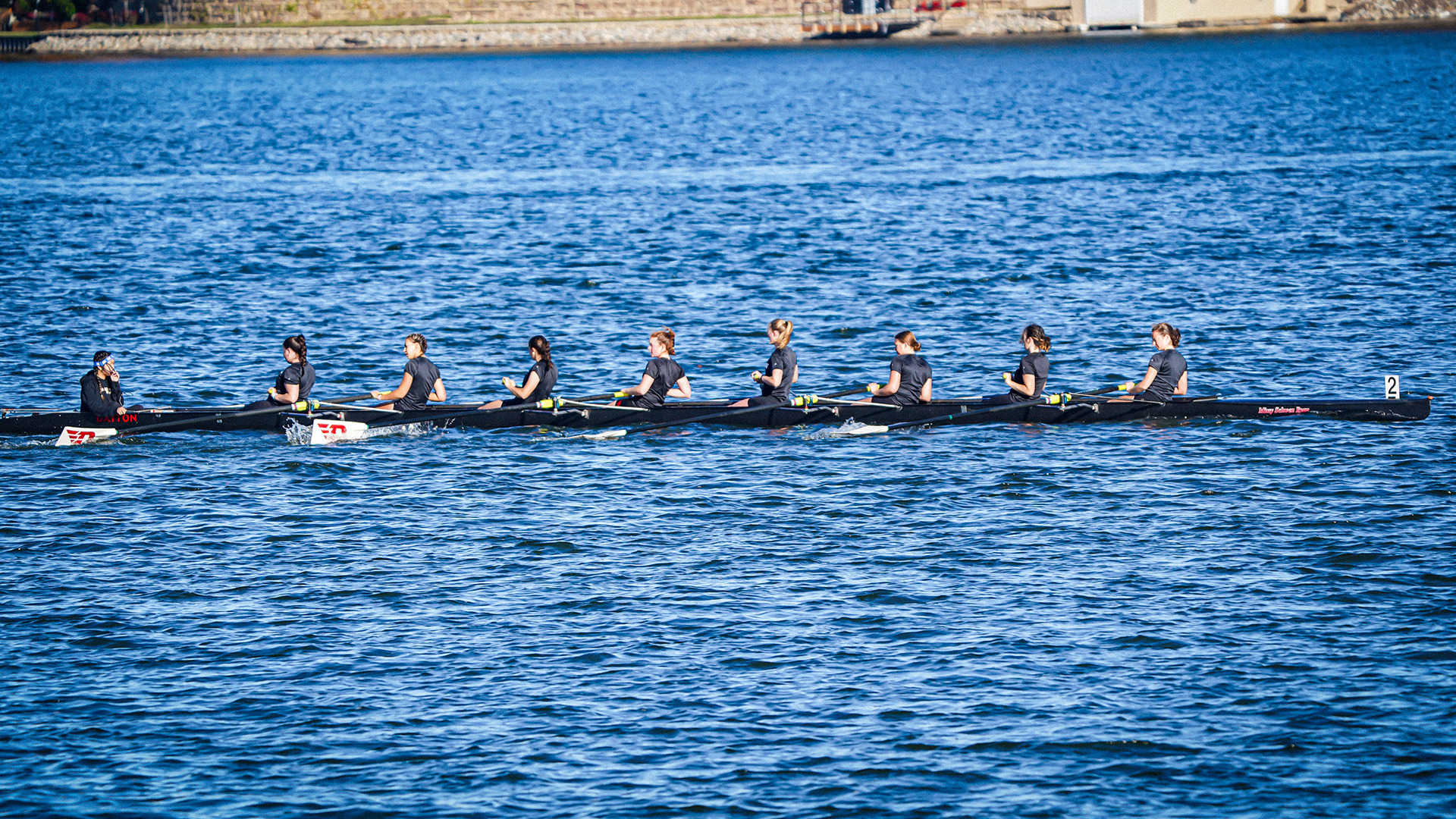 The varsity 8+ boat racing at Eastern Michigan. 