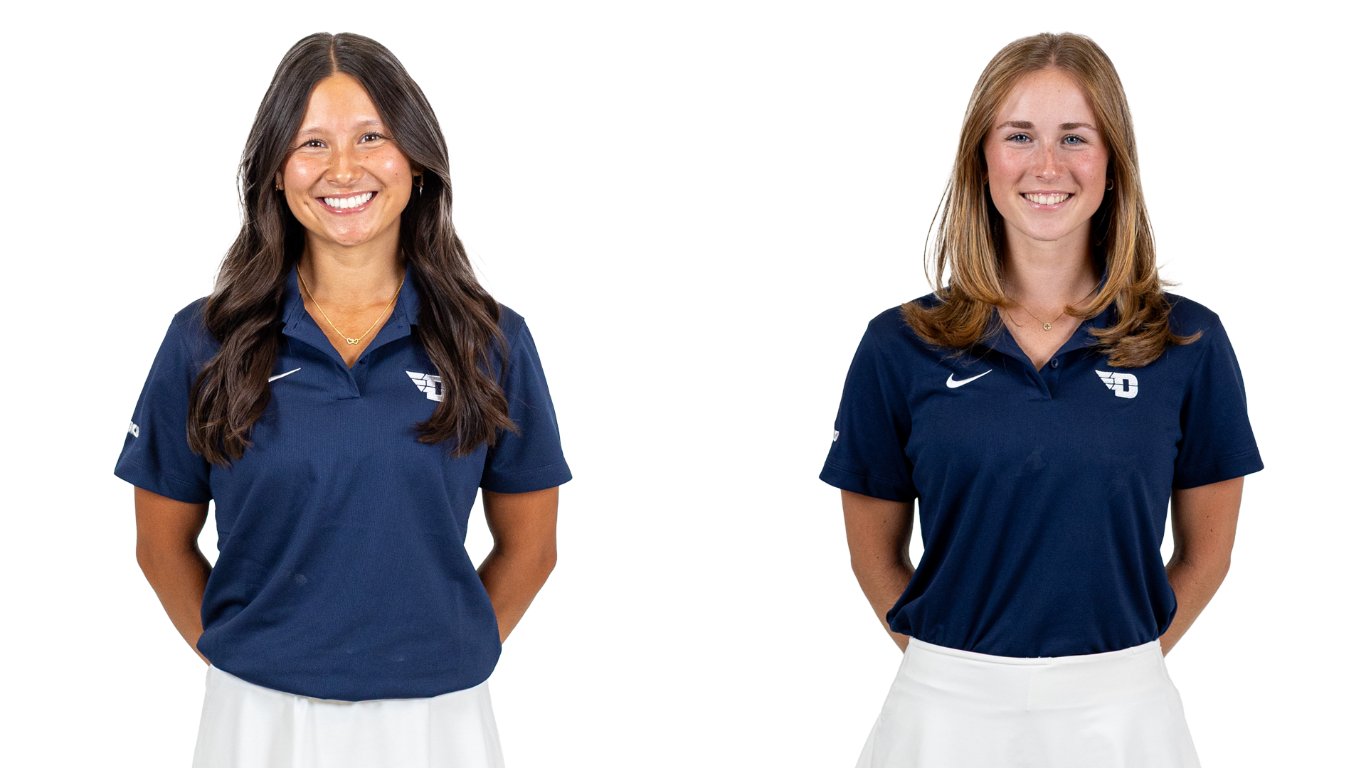 Women's golfers left to right Christina Pfefferkorn and Etta Huffman, wearing blue polo-style shirts with white Nike and D logos and white skirts, on a white background