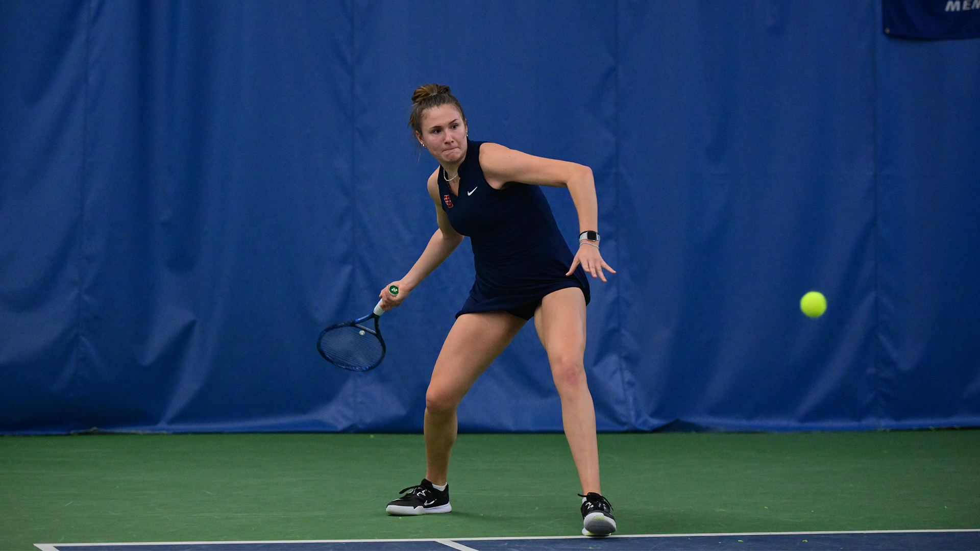 Natalie Osiecki winds up to swing at the tennis ball in the right of the picture.