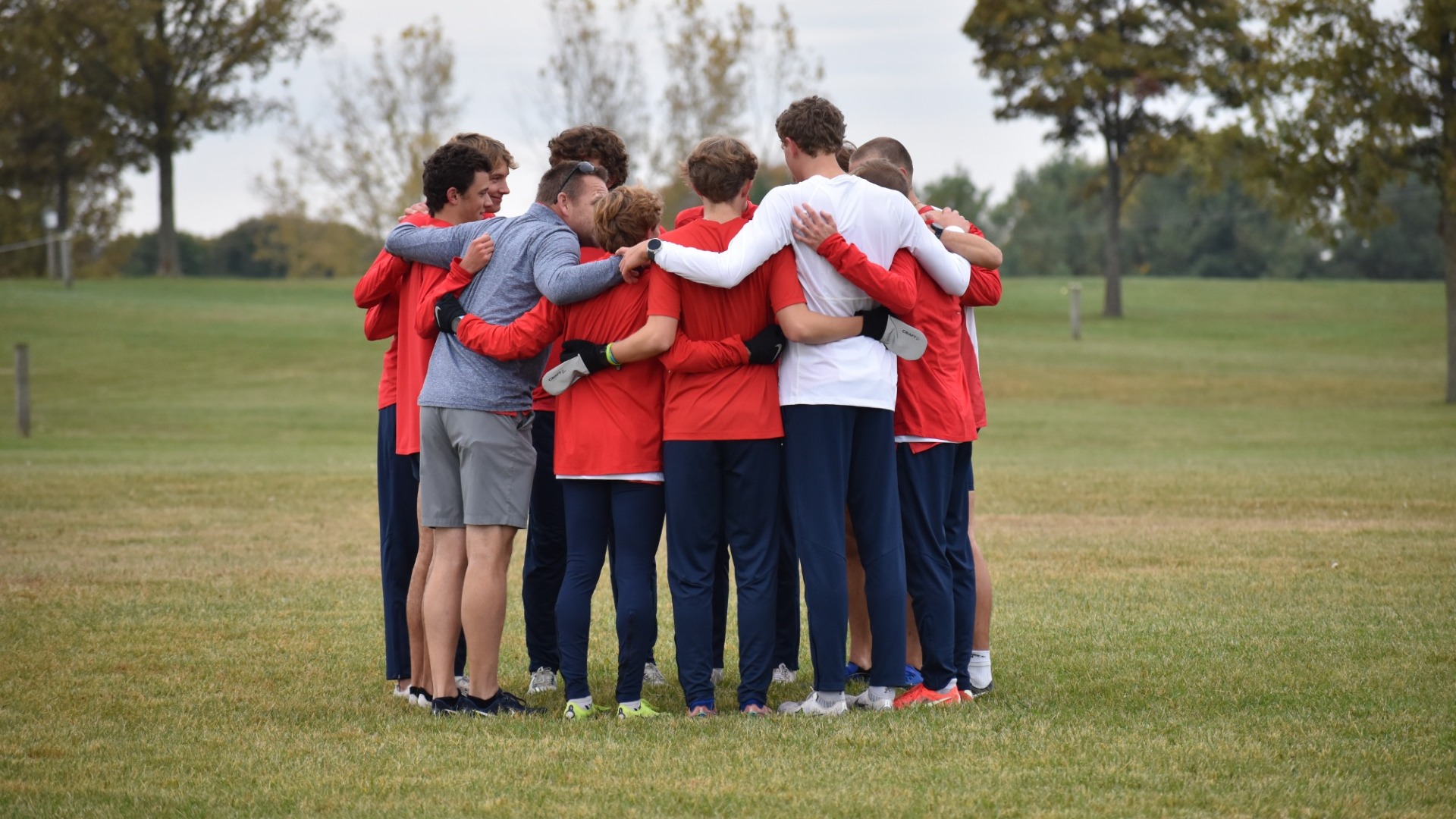 Men's Cross Country huddles together before their race at the A-10 Championships
