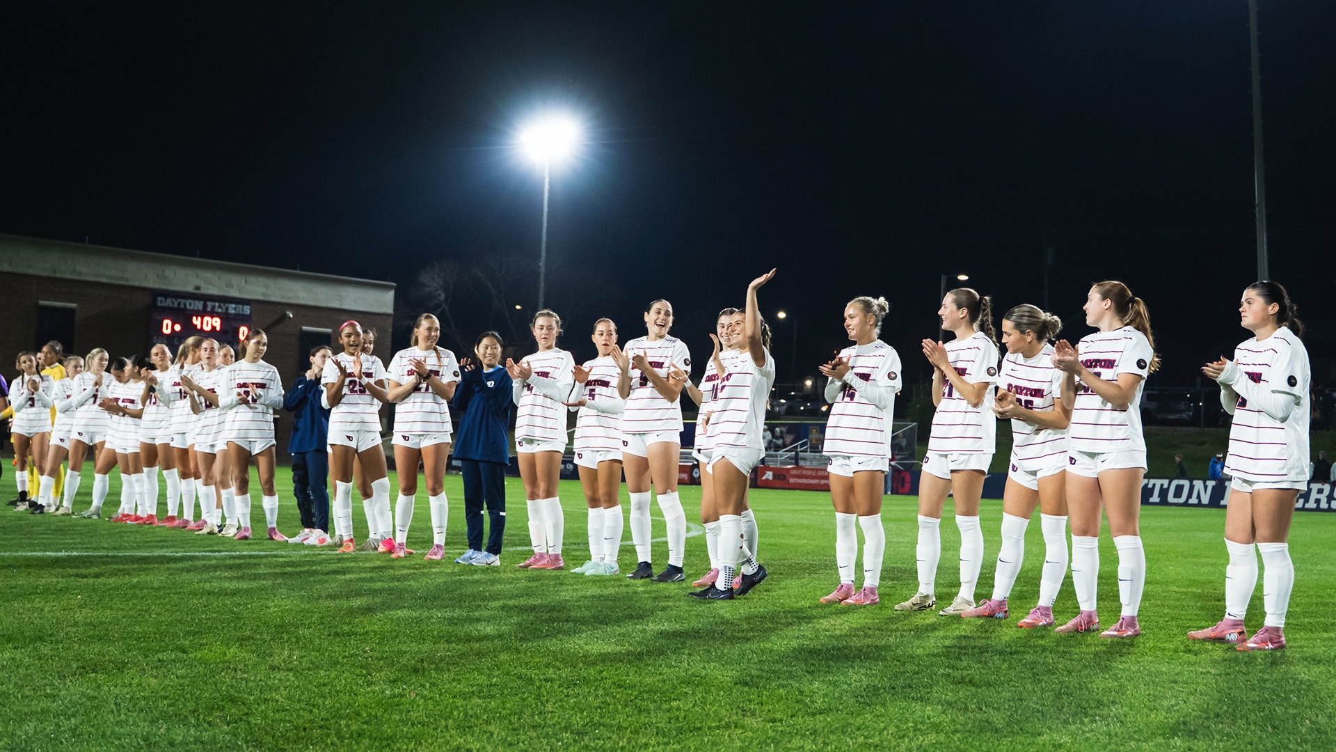 The Dayton women's soccer team standing on Baujan Field prior to the start of the Atlantic 10 Championship semifinal match.