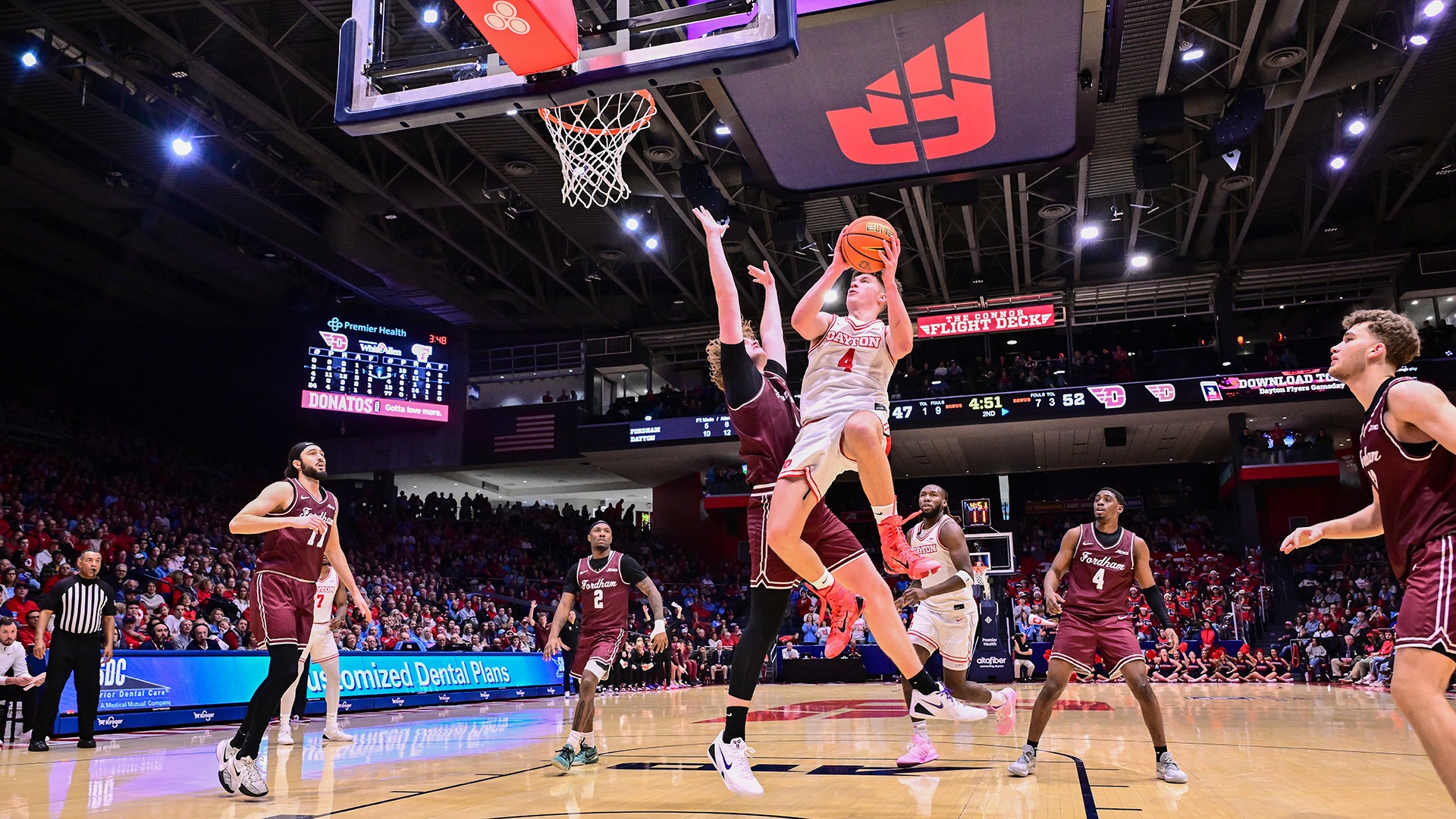 Dayton men's basketball player Jordan Derkack goes up for a basket with a Fordham defender guarding him at UD Arena.