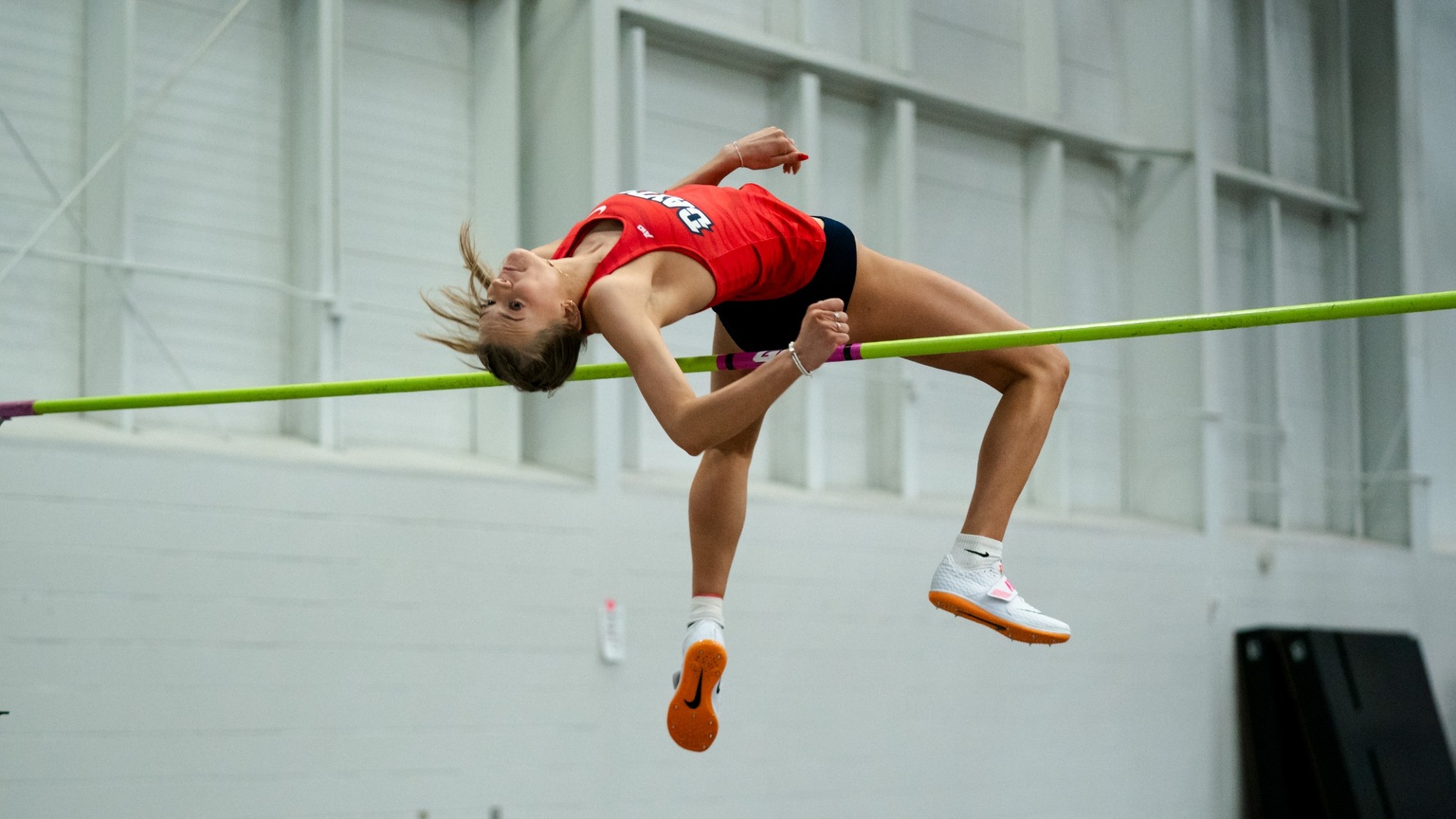 Camryn Thompson over the bar mid-jump