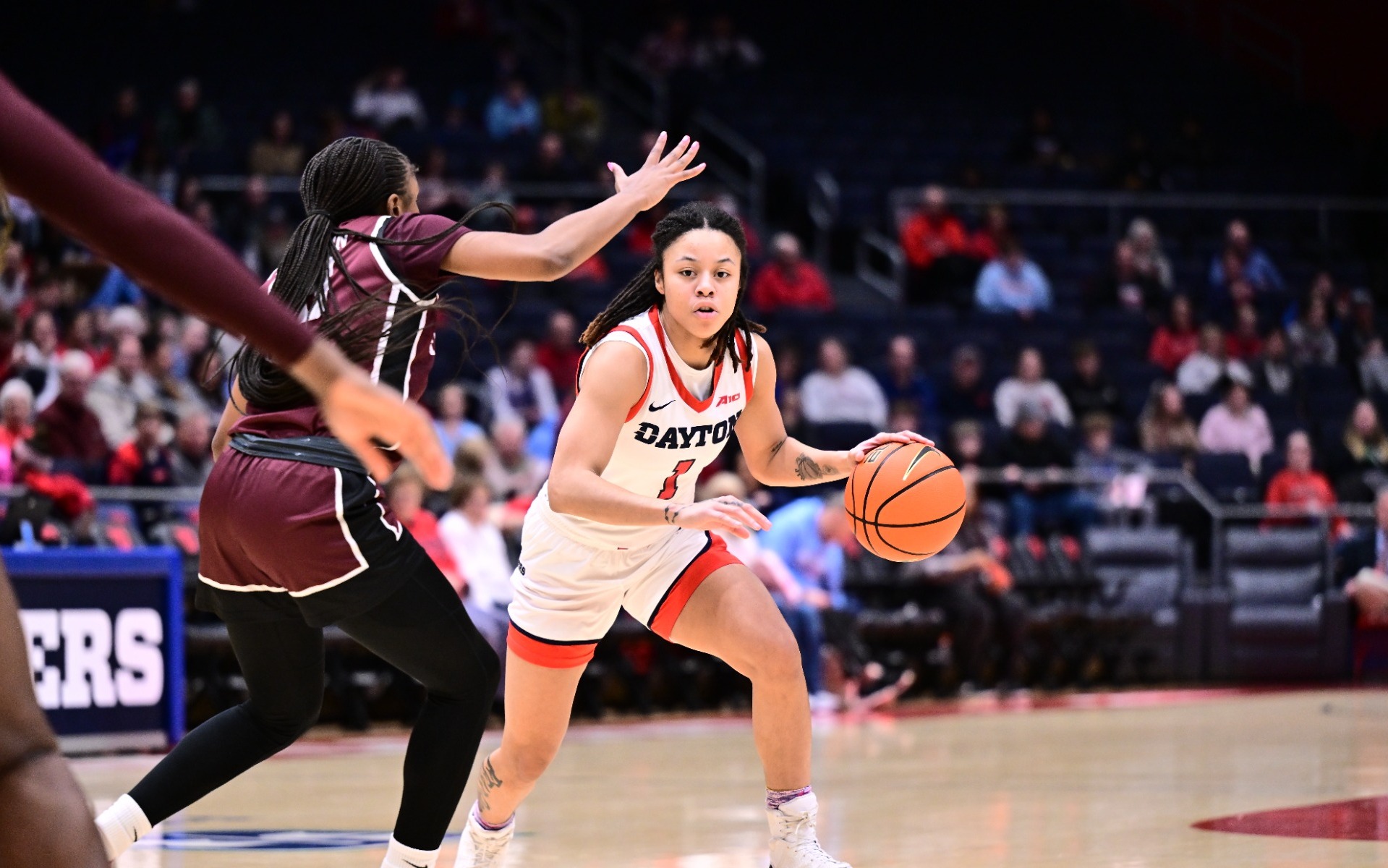 Nayo Lear dribbles past defender 
