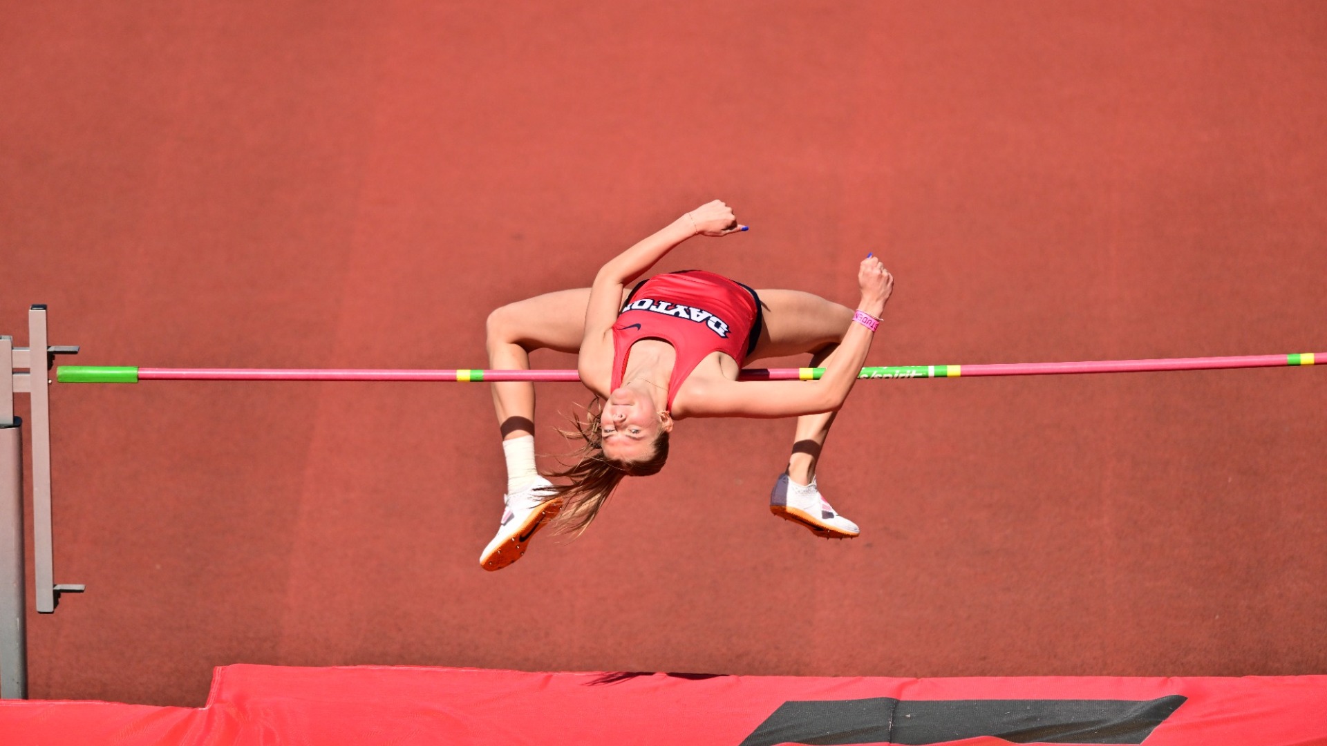 Camryn Thompson leaps over the bar in the high jump