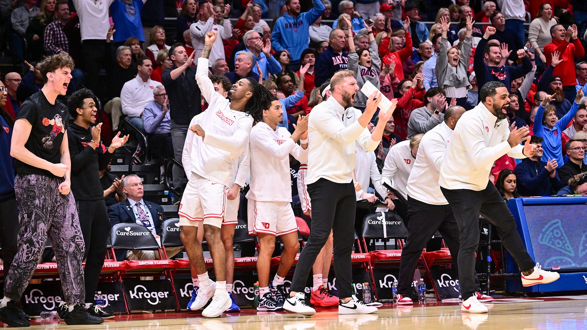 The Dayton men's basketball bench reacts to a basket being scored against George Washington.