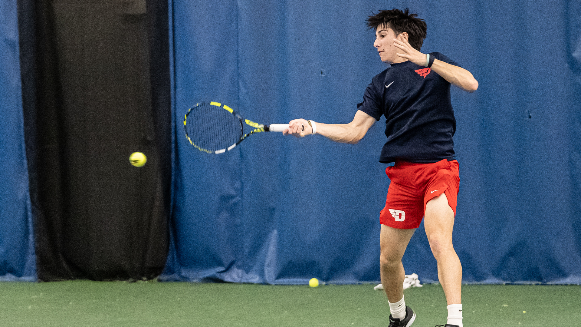 McNally swings at a ball. His right arm is extended.