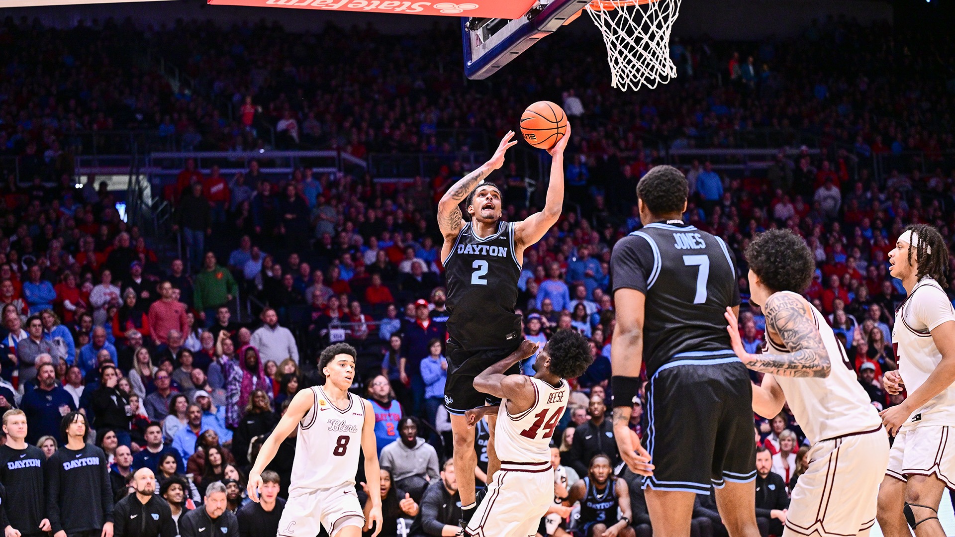 Dayton men's basketball player De'Shayne Montgomery drives to the basket against Loyola-Chicago wearing the Stealth Black jerseys at UD Arena.