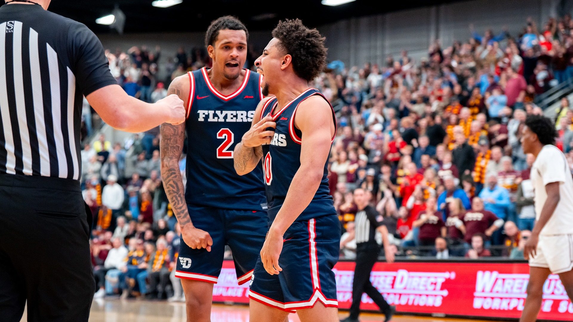 Dayton men's basketball player Javon Bennett celebrates scoring the game-winning basket against Loyola.