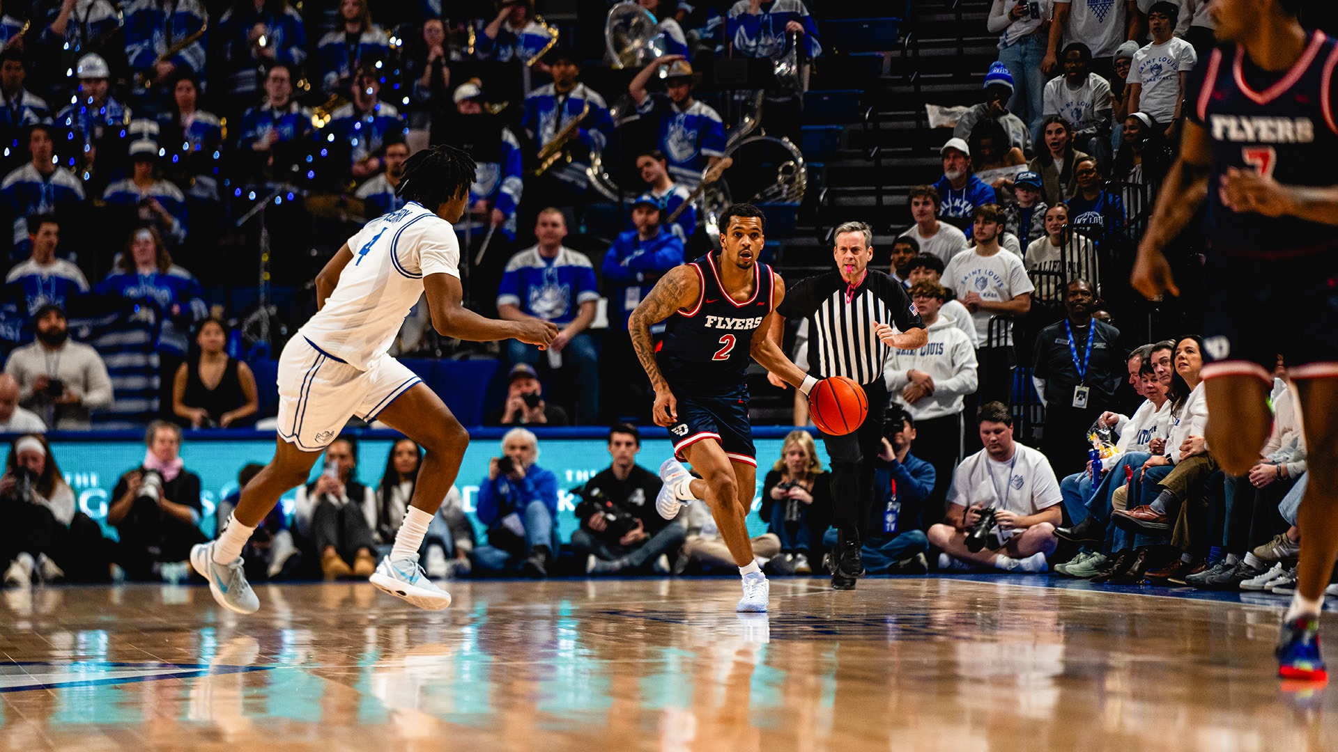 Dayton men's basketball player De'Shayne Montgomery dribbles with the left hand with a Saint Louis defender guading him.