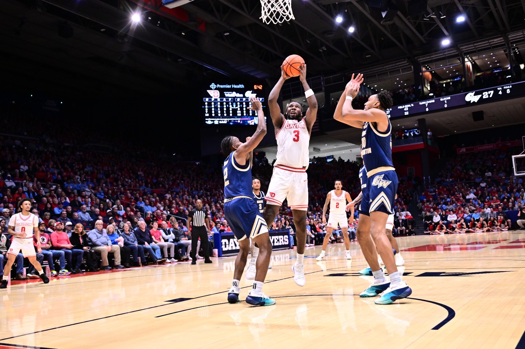 Dayton men's basketball player Jaiun Simon goes up for a shot against George Washington.