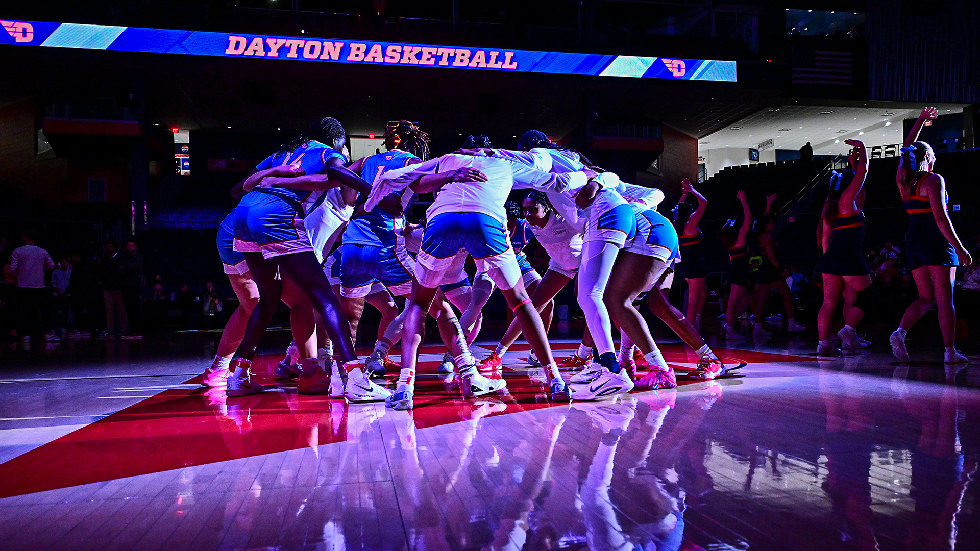The women's basketball team huddling before the game. 