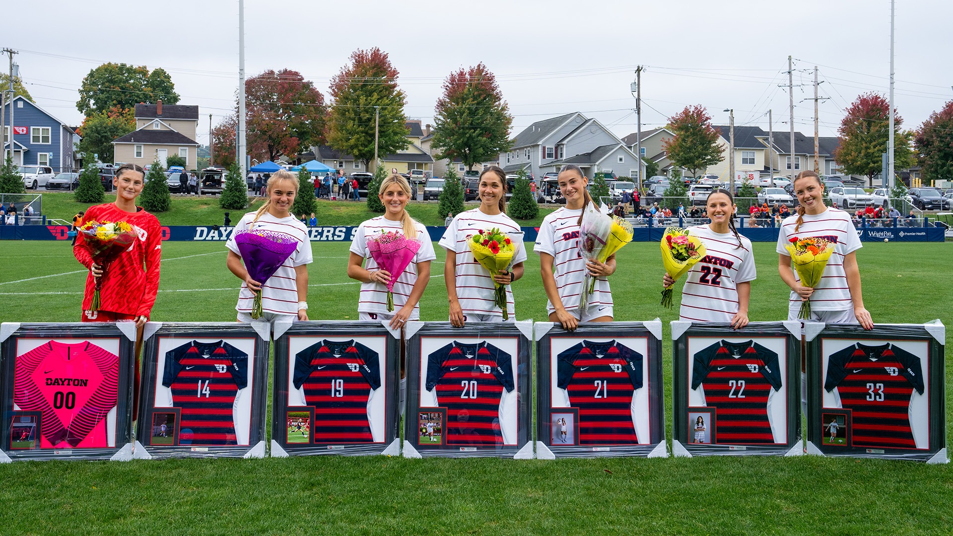 The 2026 Dayton Seniors stand with their senior gifts and flowers prior to their match against George Washington.