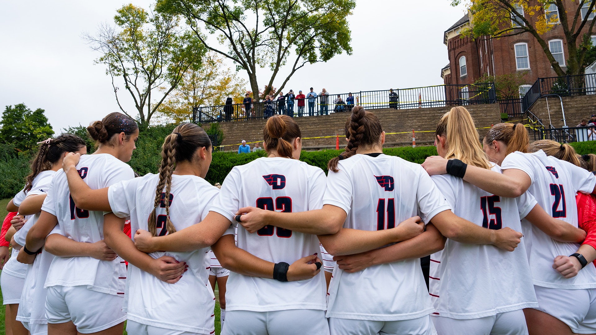 The Dayton Flyers, wearing white jerseys, huddle together prior to their game against George Washington.