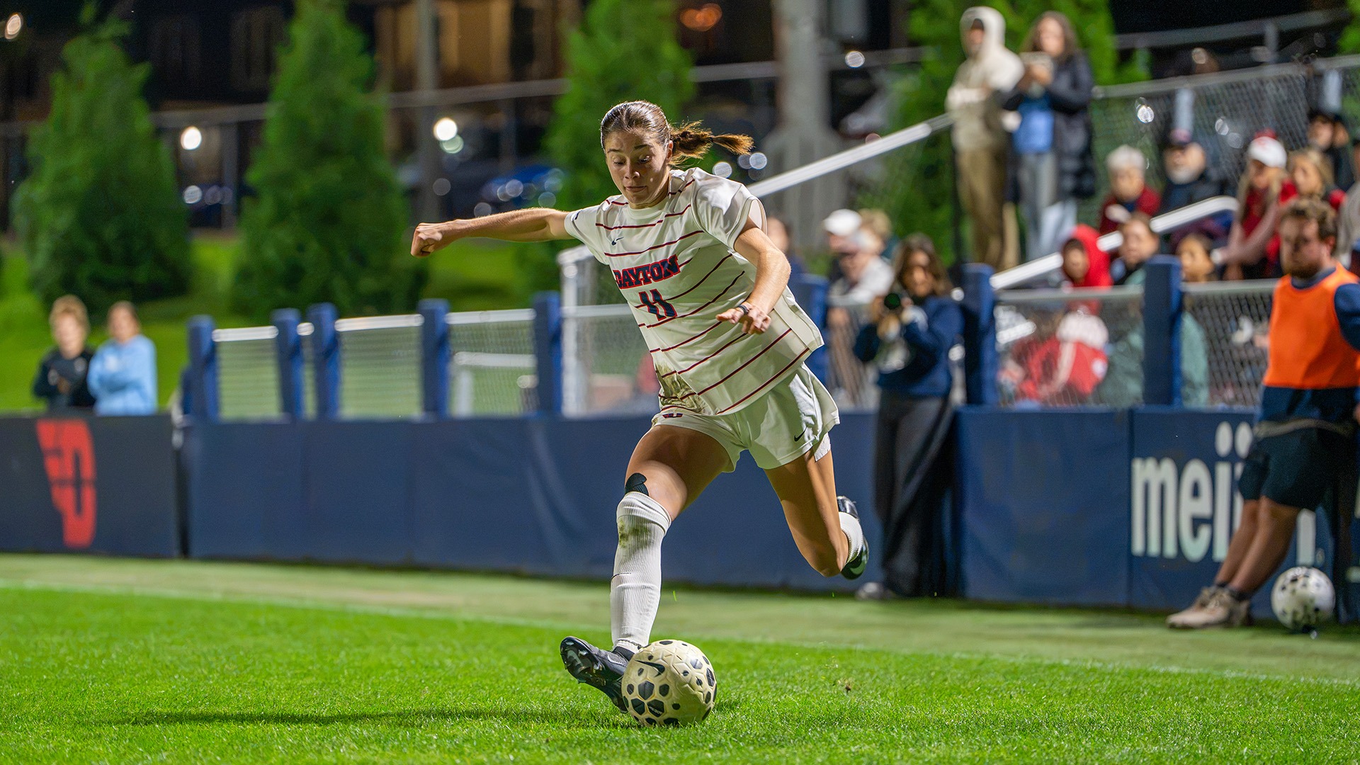 Dayton women's soccer player Liv Grenda readies to kick a ball under the lights of Baujan Field.