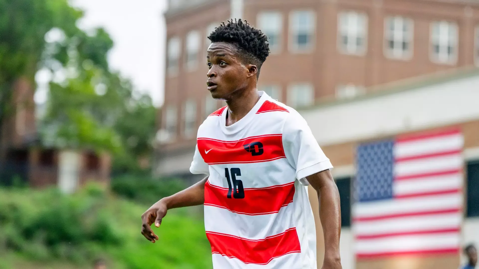 Gyau on field playing against RMU wearing Dayton's white with red stripes uniform