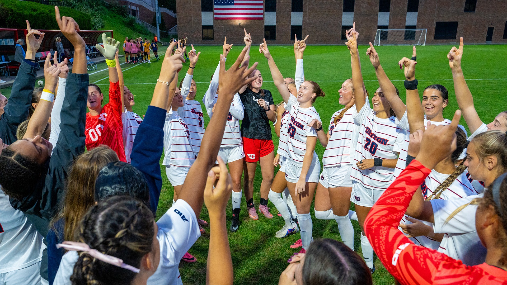 The Dayton women's soccer team finishes their cheer before they start their match against La Salle.