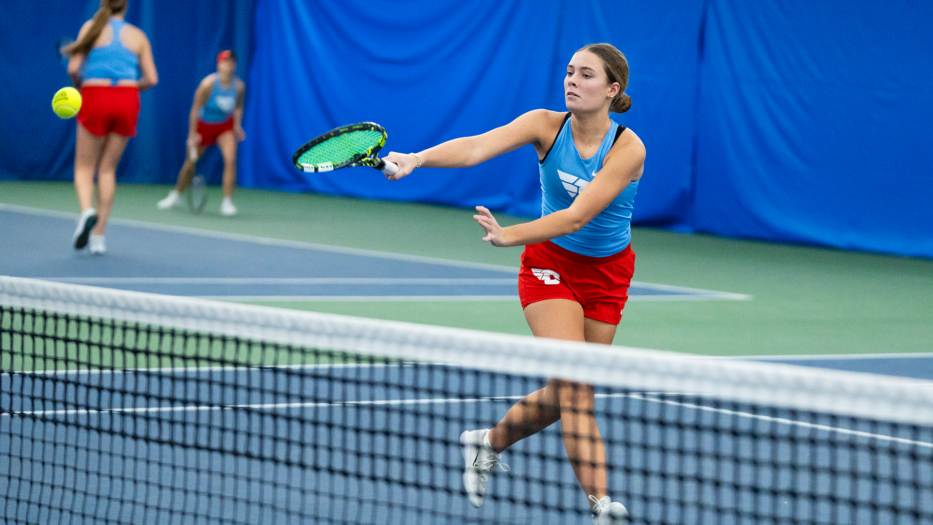 Mallory Hitchcock backhands a ball.