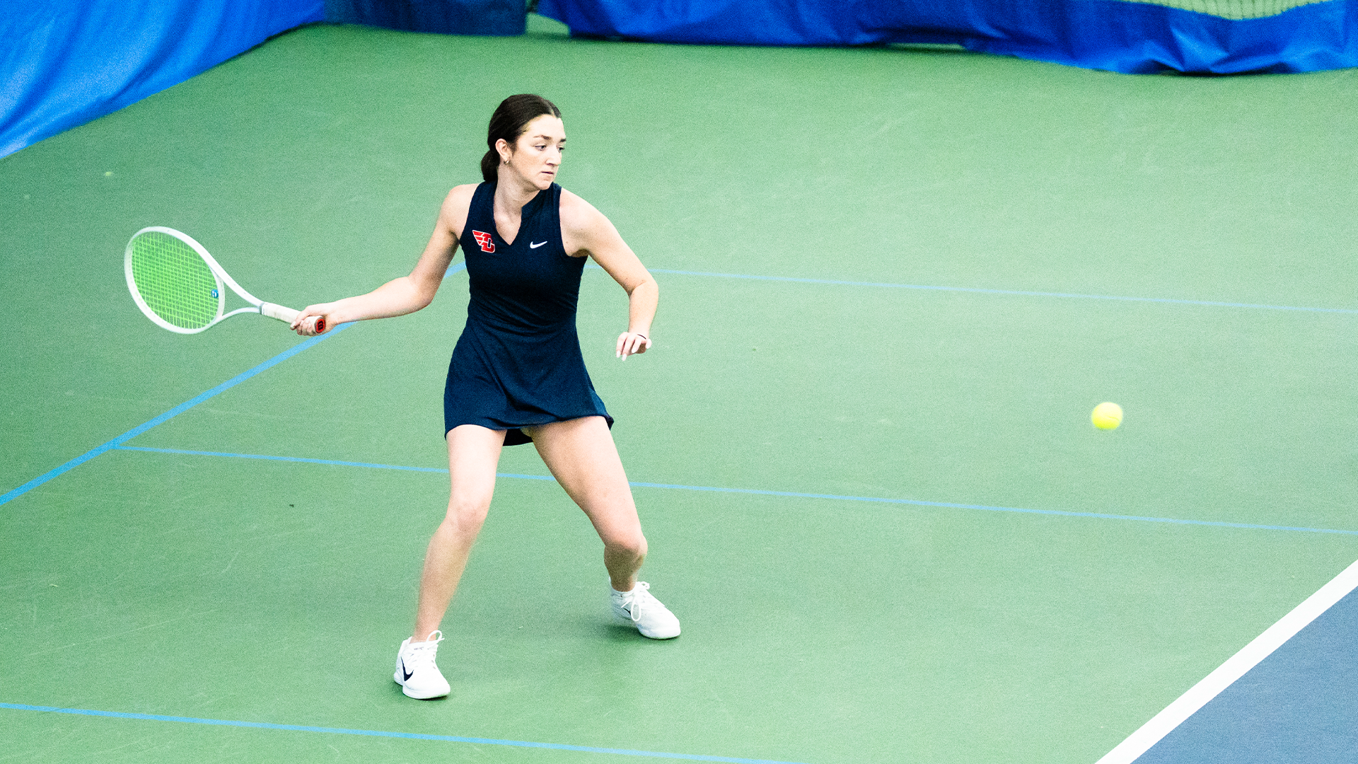 Haley Klein winds up to hit in ball in the right of the frame.
