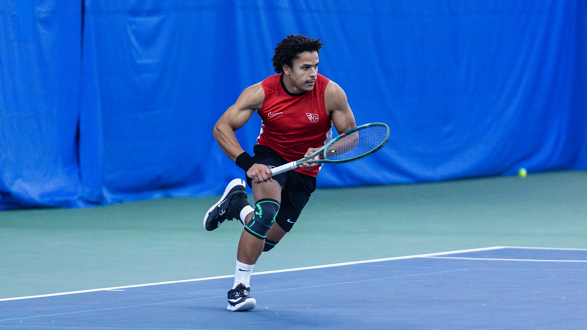 Kaia Mendibe runs towards a ball that is out of frame.