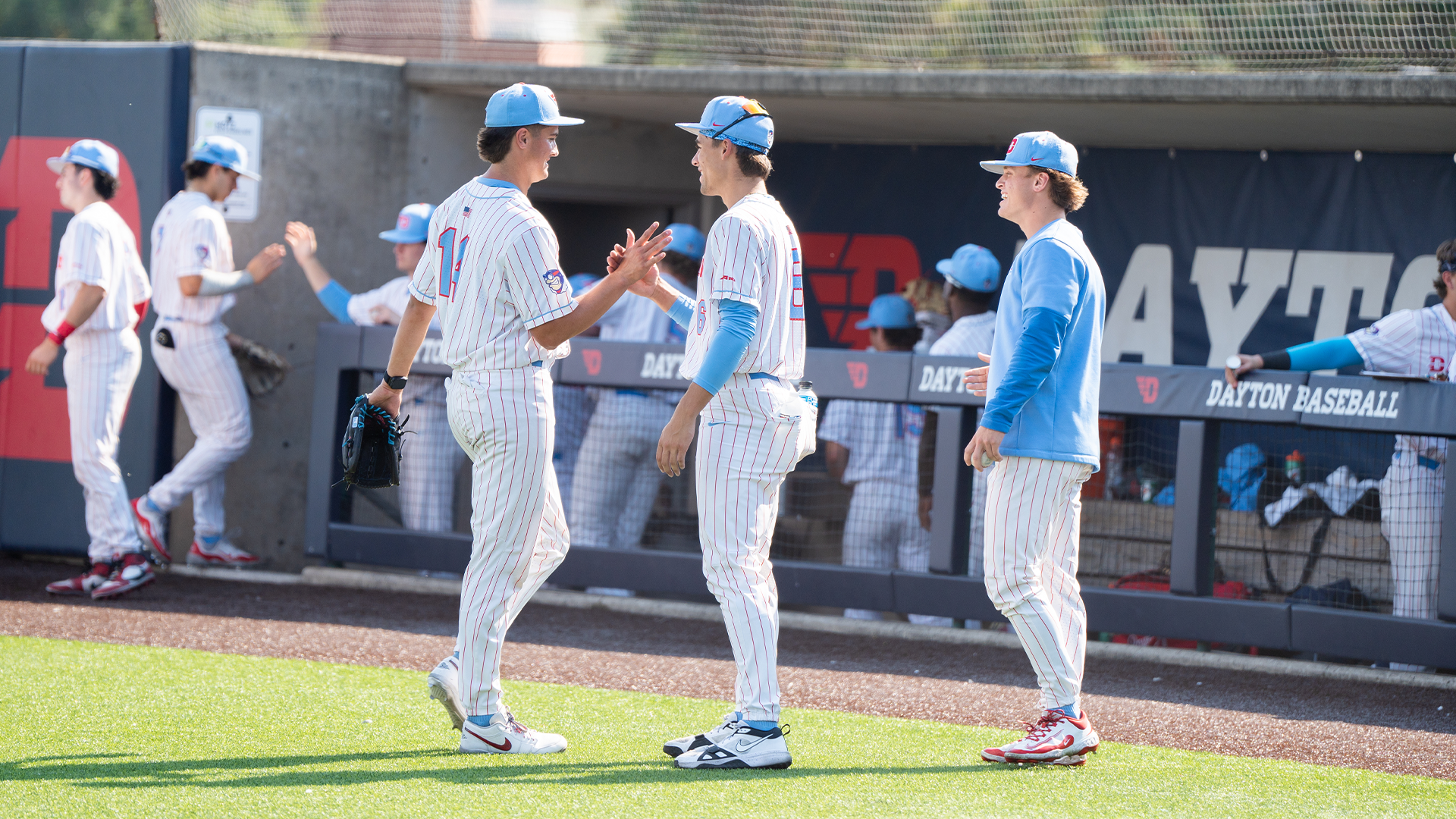 Peyton Malecha high fives a teammate on his way to the dugout.