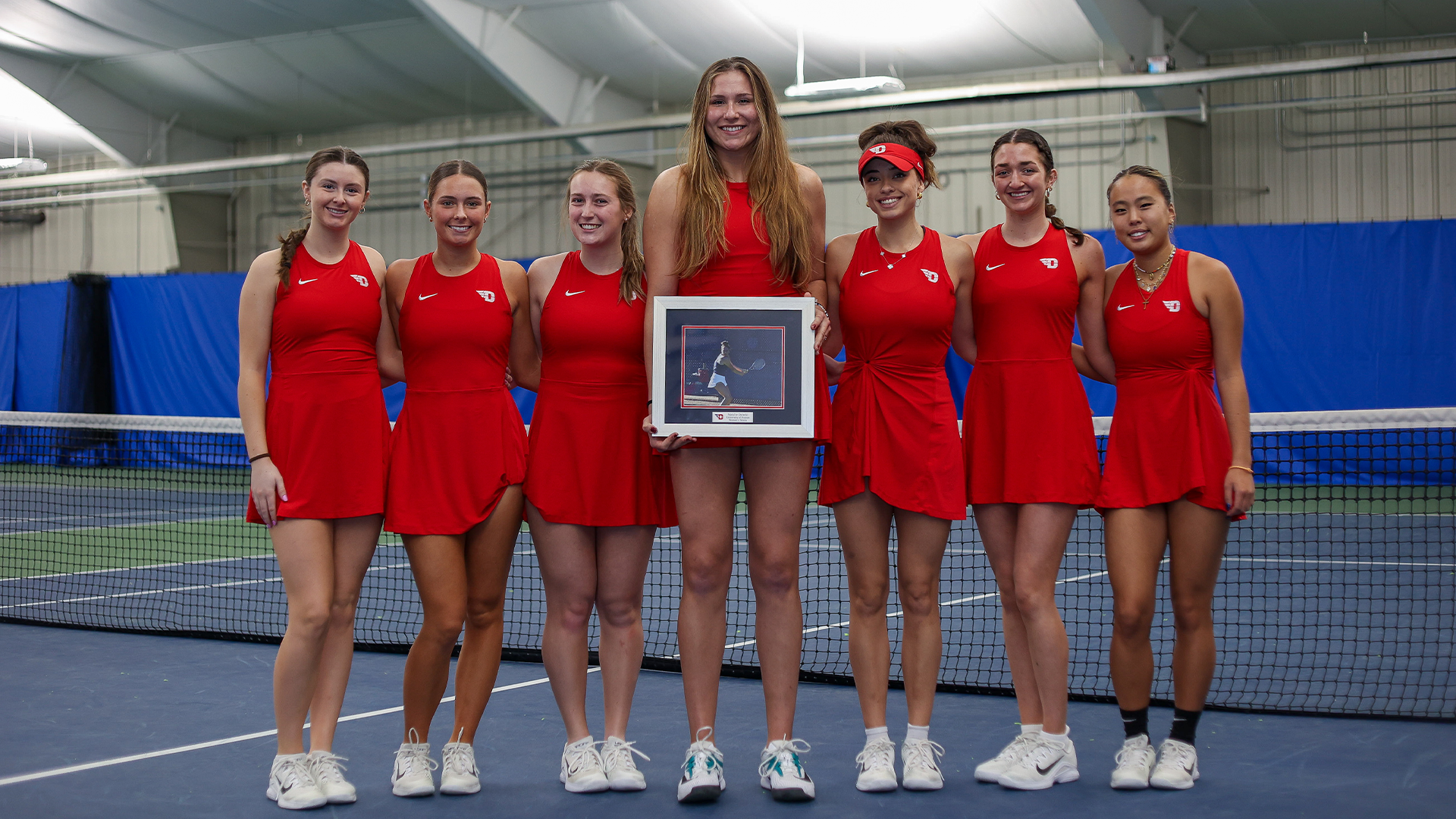 The team poses for a picture on Senior Day with Natalie Osiecki in the middle.