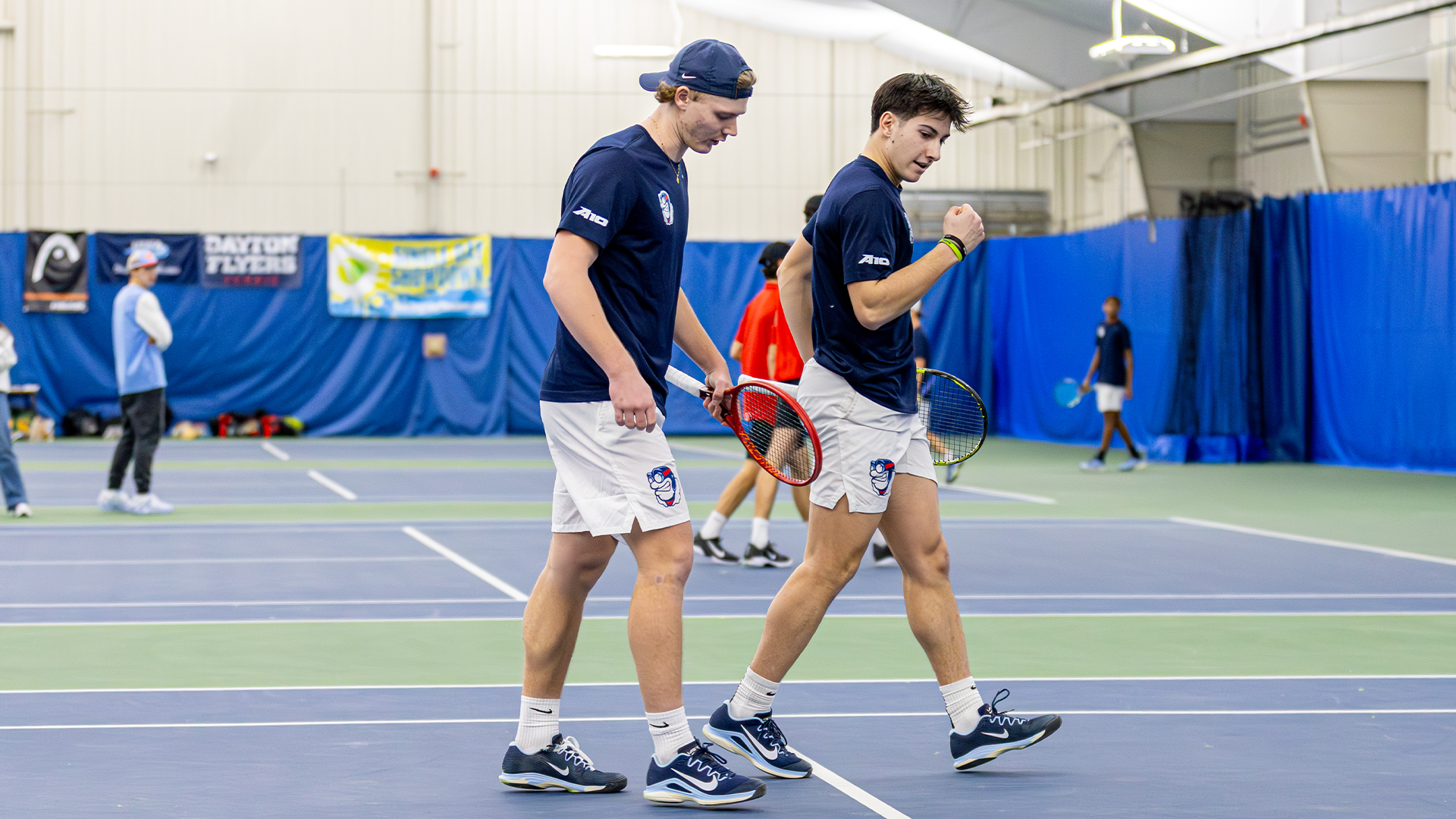 Kyle McNally and Sturle Skigelstrand strategize while walking together after a point.