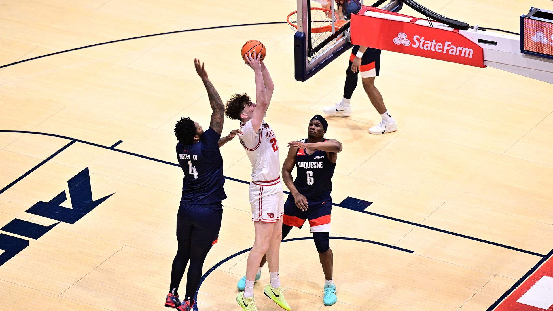 Dayton men's basketball player Amael L'Etang goes up for a short-range shot against Duquesne.