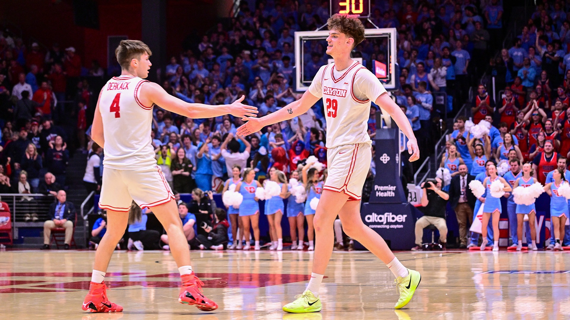 Dayton men's basketball players Jordan Derkack (left) and Amael L'Etang (right) high five after a basket against Saint Louis.