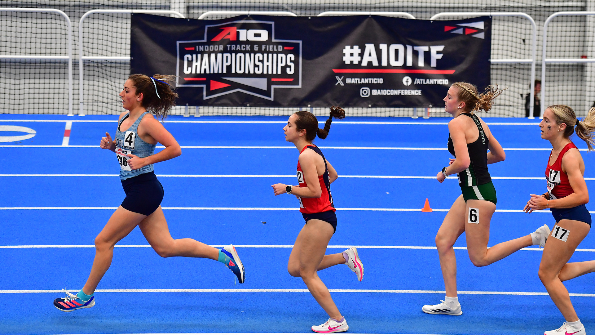 Marissa Pritchett runs in the middle of the race in front of a banner that reads 