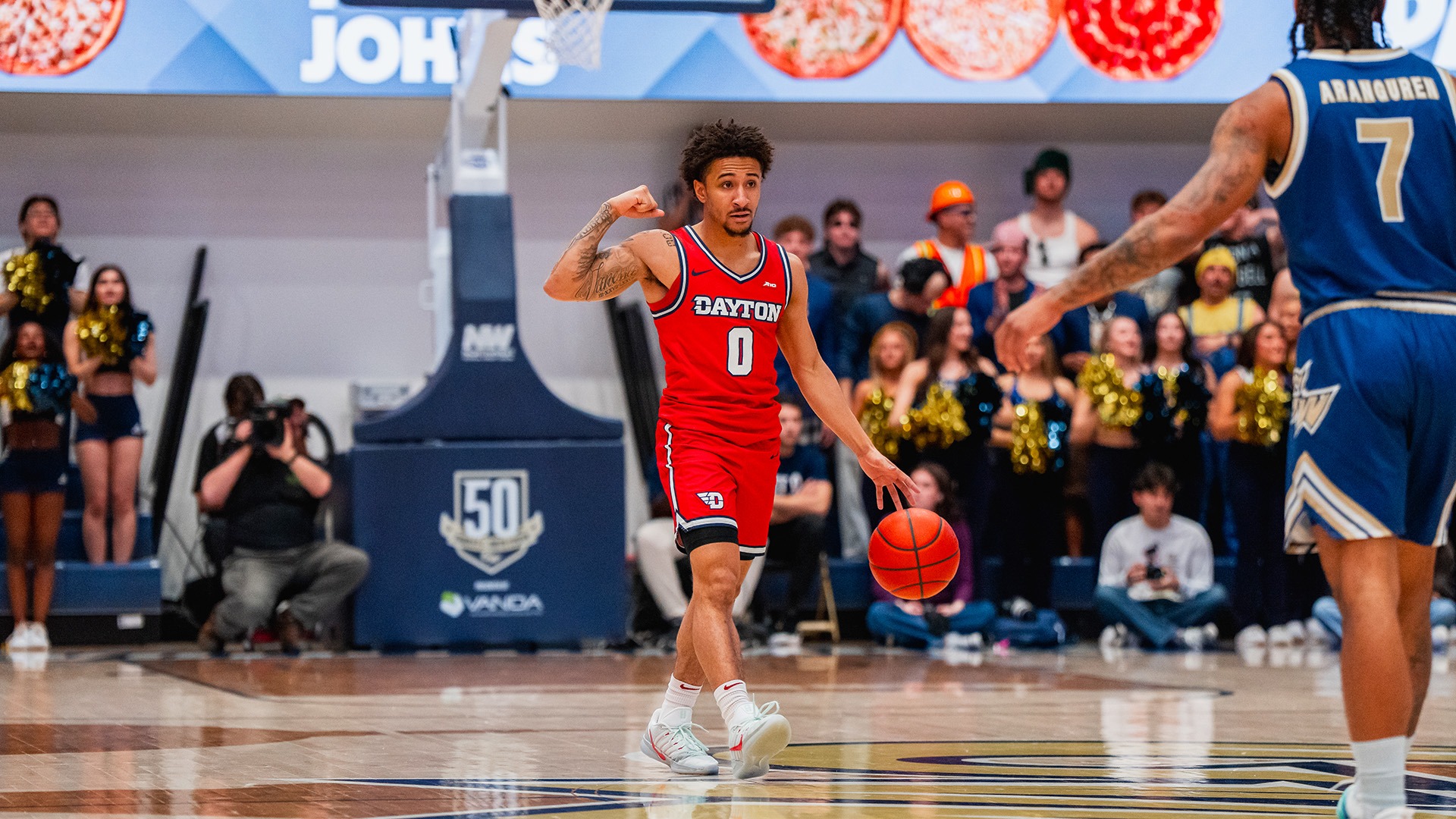 Dayton men's basketball player Javon Bennett calls out a play while bringing the ball up the court against George Washington.