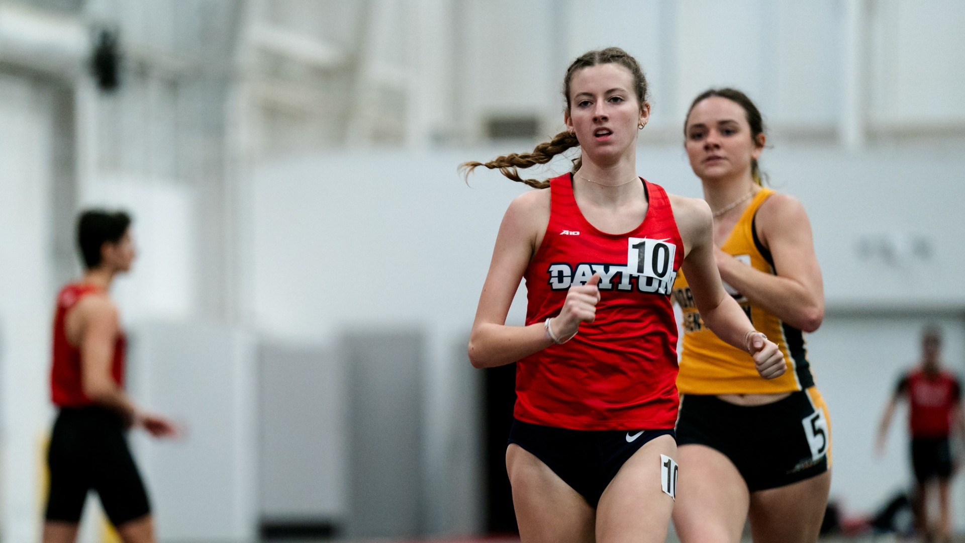 Kaitlin Skelton runs toward the camera with an opponent in the background