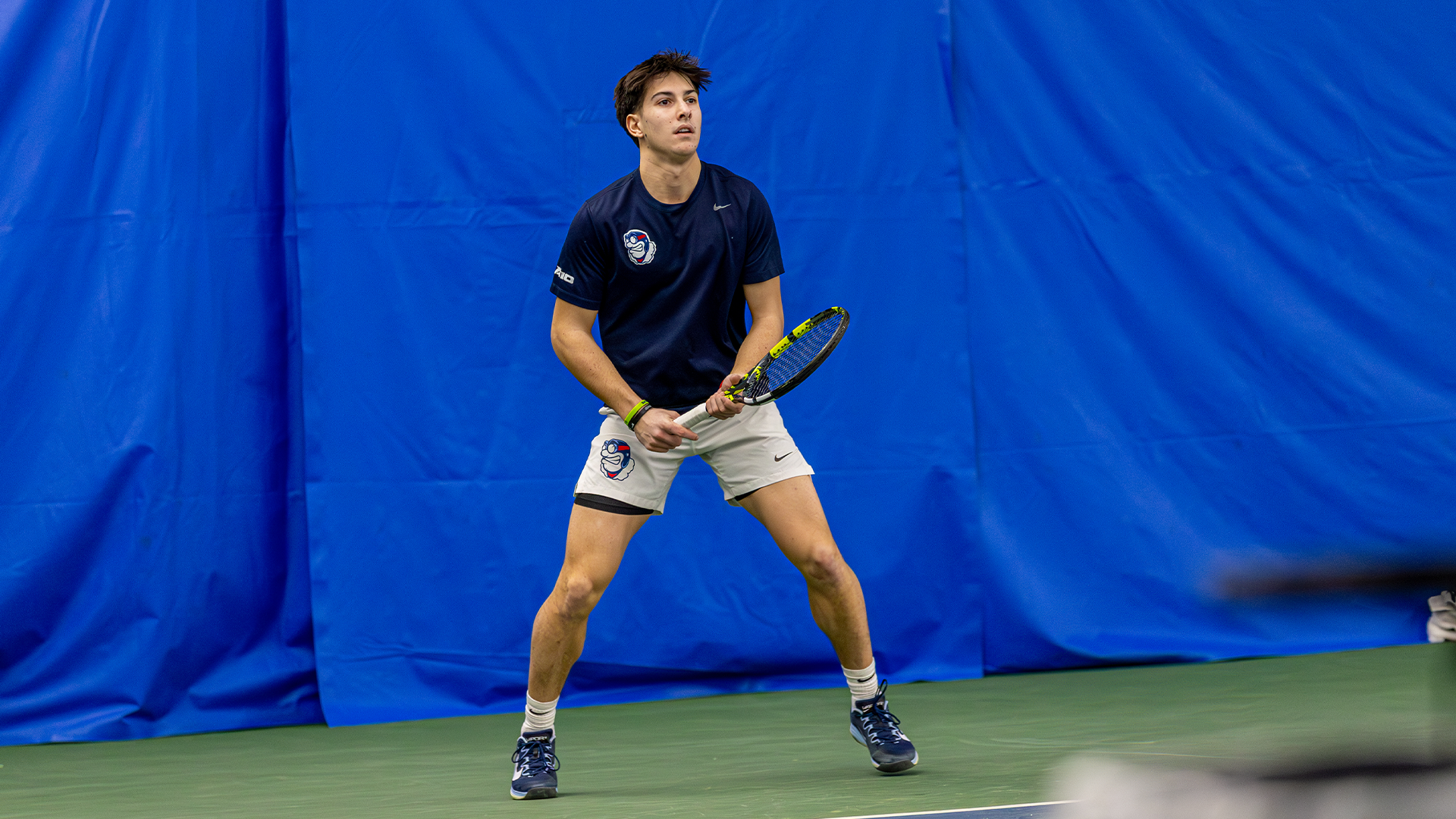 McNally bounces on his toes before his opponent serves.