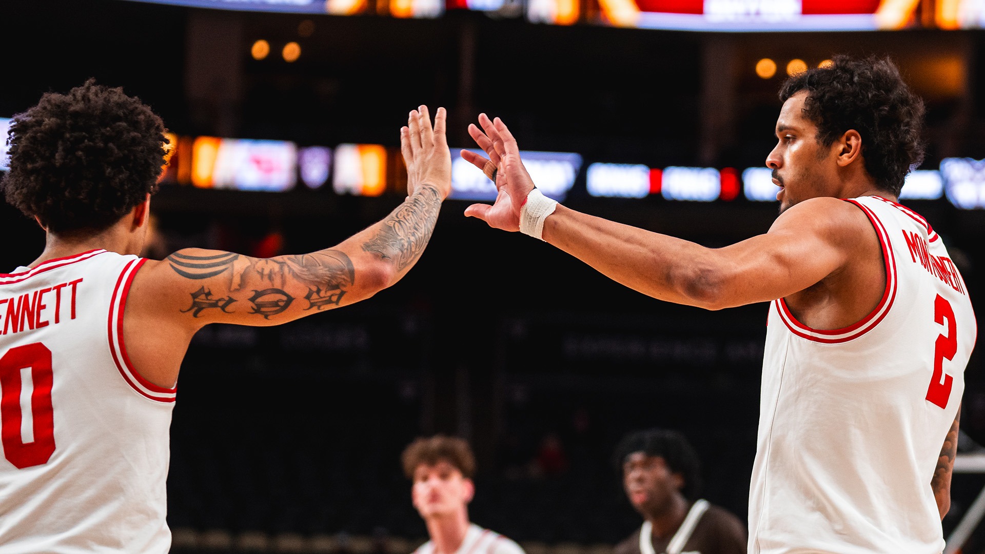 Dayton basketball players Javon Bennett and De'Shayne Montgomery high five.