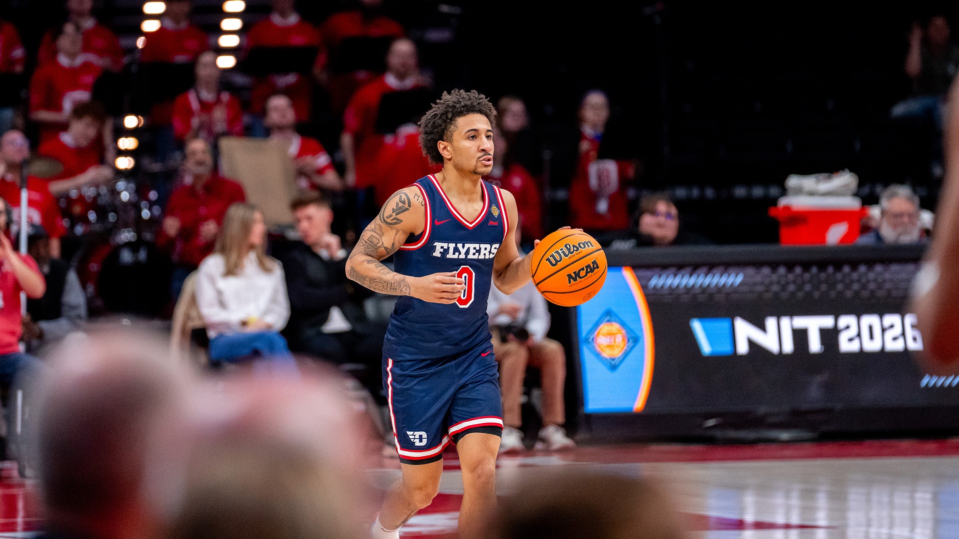 Dayton men's basketball player Javon Bennett brings the ball up the court at Bradley during the opening round of the NIT.