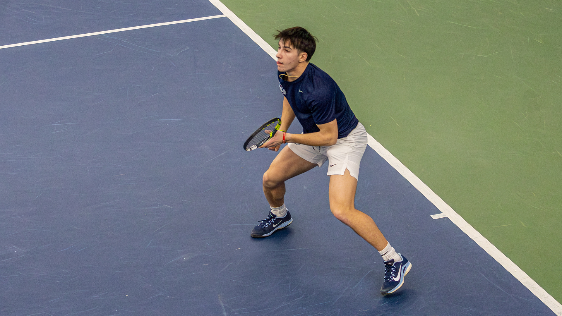 Kyle McNally stands on his toes as he waits for the serve.