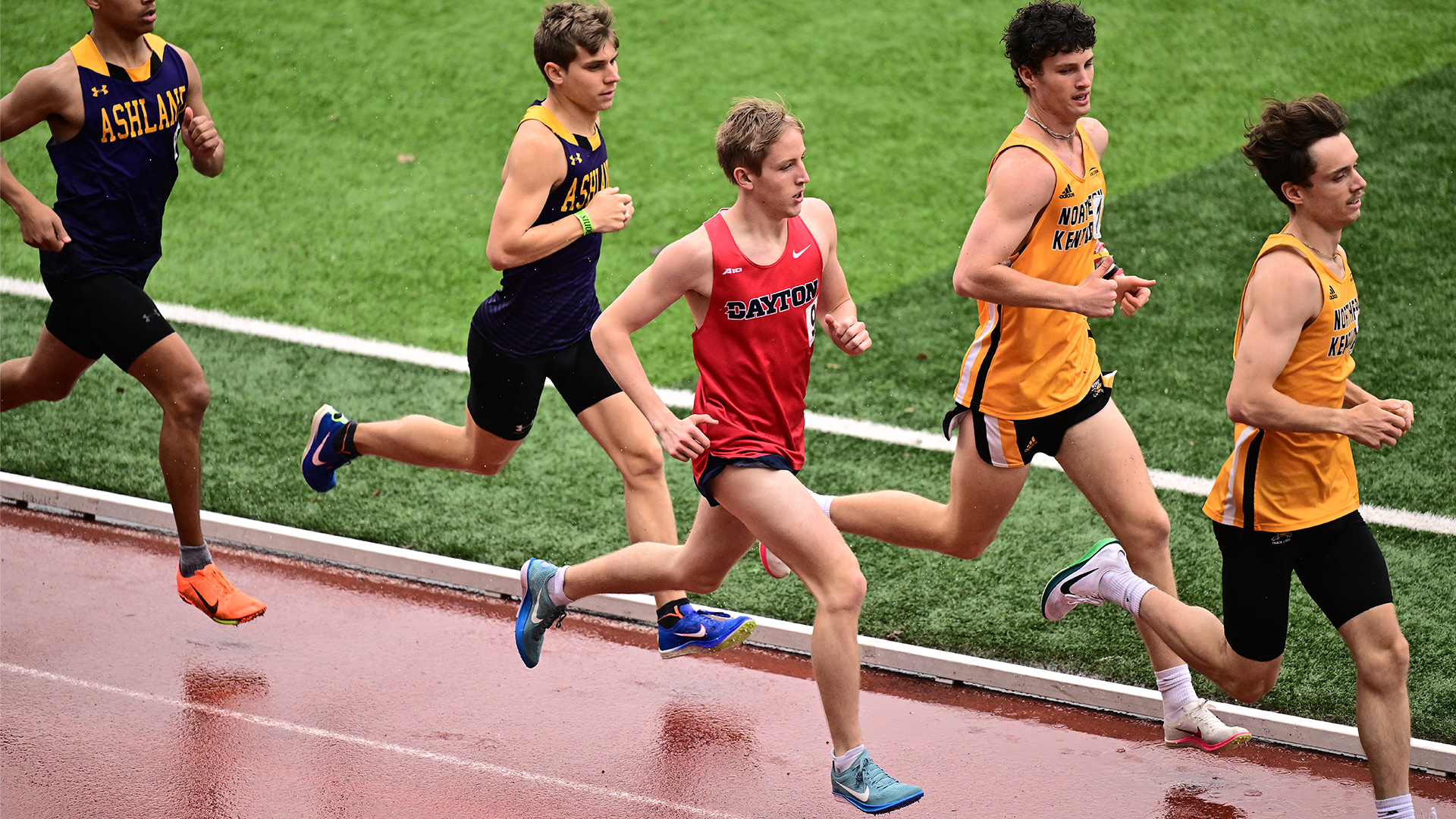 Jacob Herzog runs in a crowd of competitors on the track