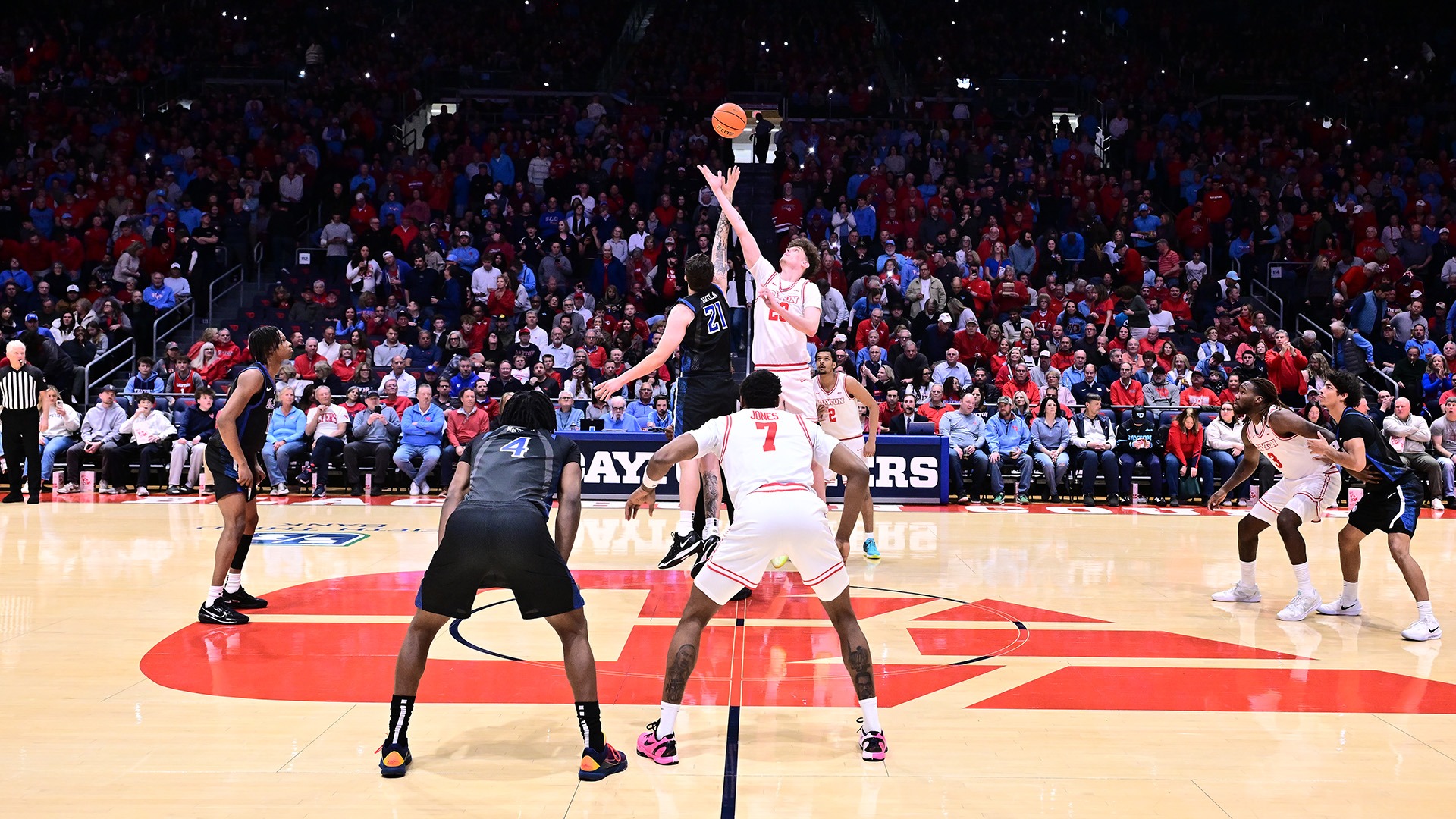 Dayton men's basketball player Amael L'Etang goes up for the jump ball against Saint Louis in UD Arena.
