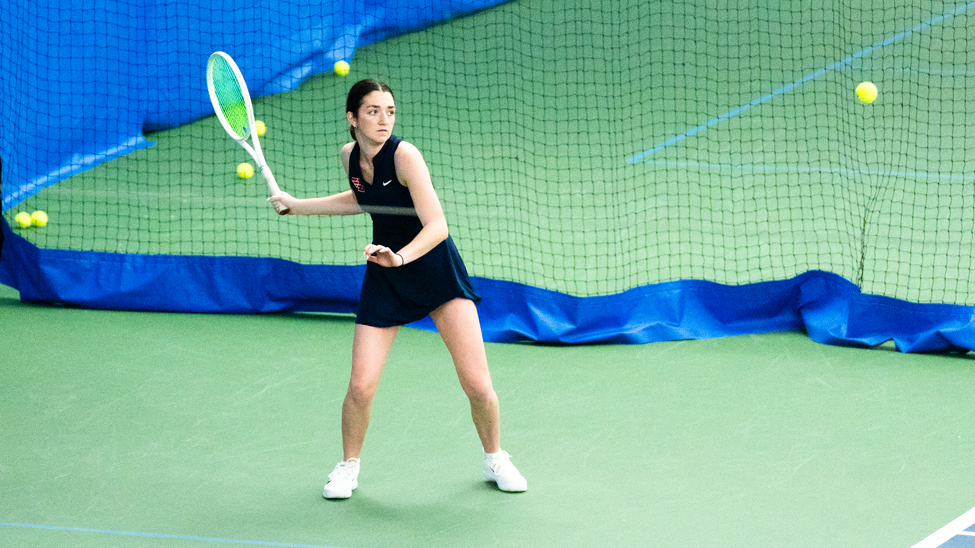 Haley Klein winds up her racquet to hit the ball on the right side of the frame.