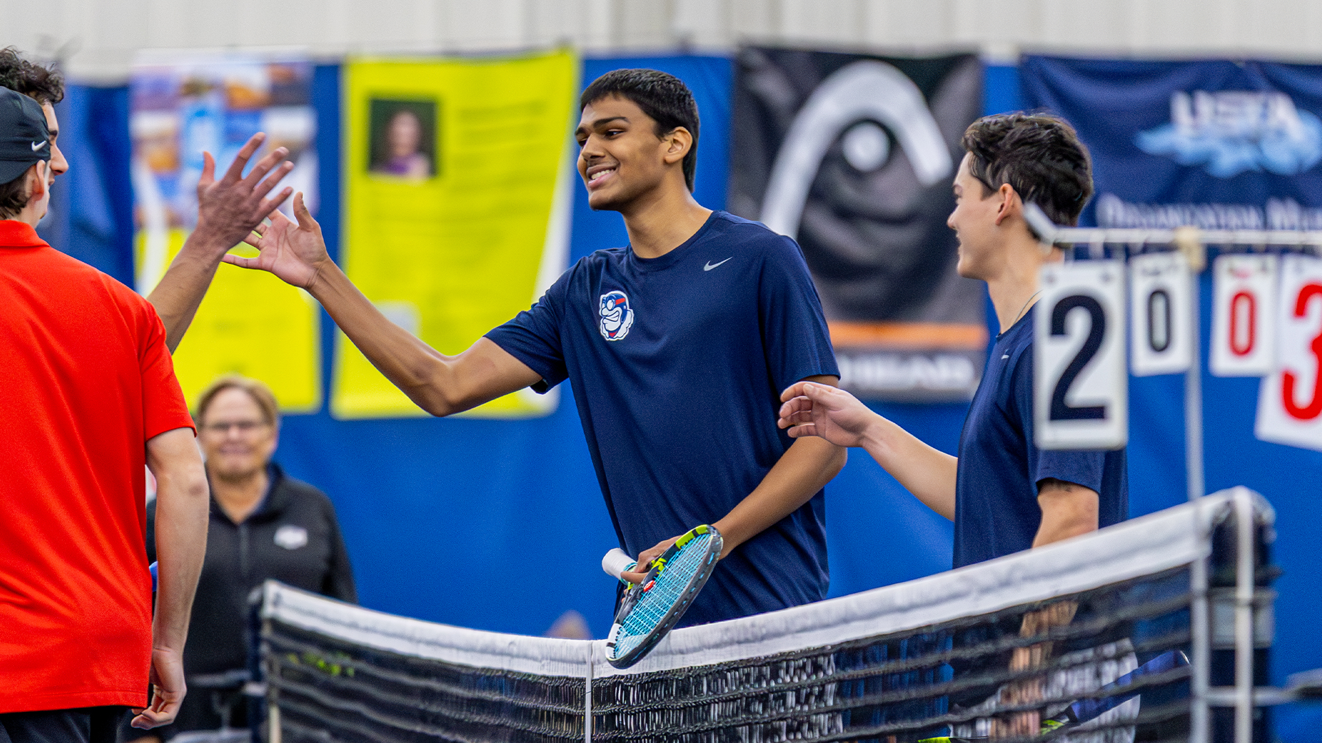 Rishi Dore smiles and shakes the hands of the opposing Ball State players.
