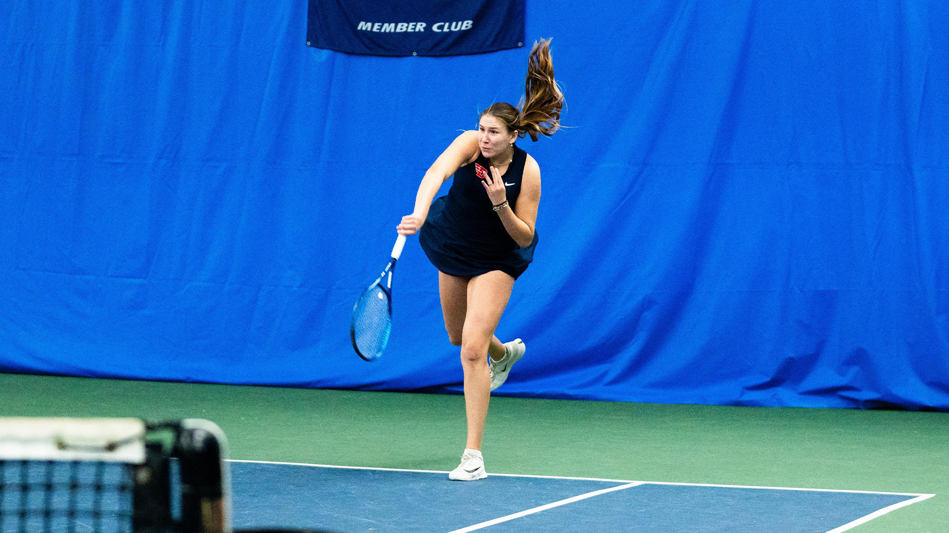 Natalie Osiecki serves the ball.