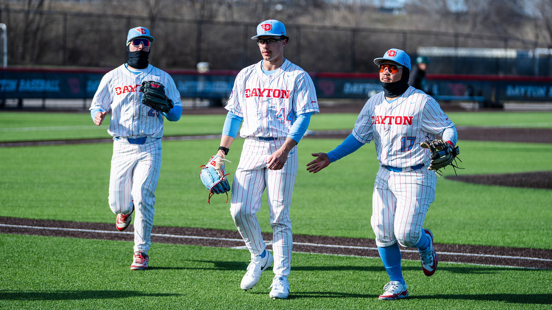Grayson Carpenter, John Delgado and Dyrenson Wouters jog on the field at the end of the inning.