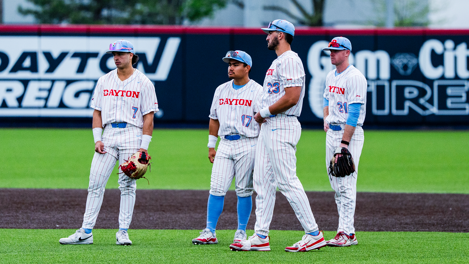 L-R: Jason Bello, Dyrenson Wouters, Bobby Stang and Danny MacDougall stand in front of second base while a pitcher warms up.