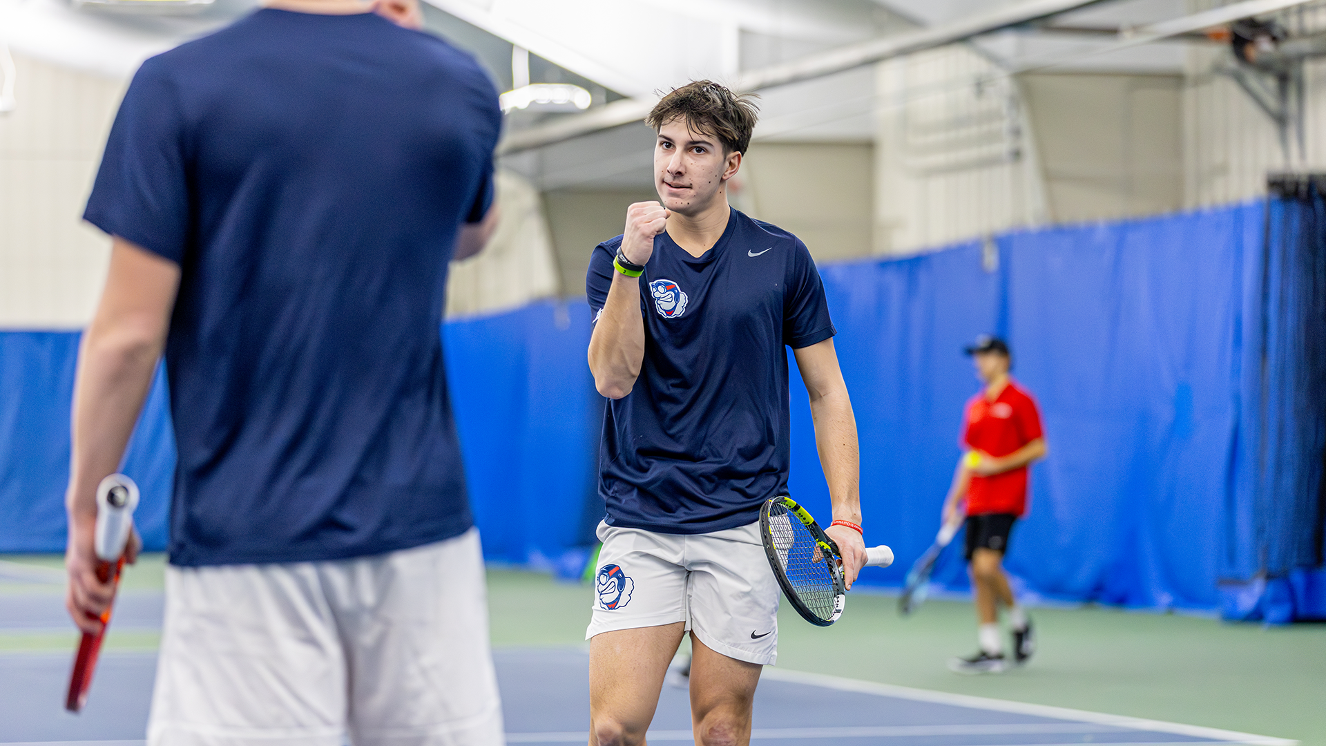 Kyle McNally pumps his fist in excitement towards a teammate after a point.